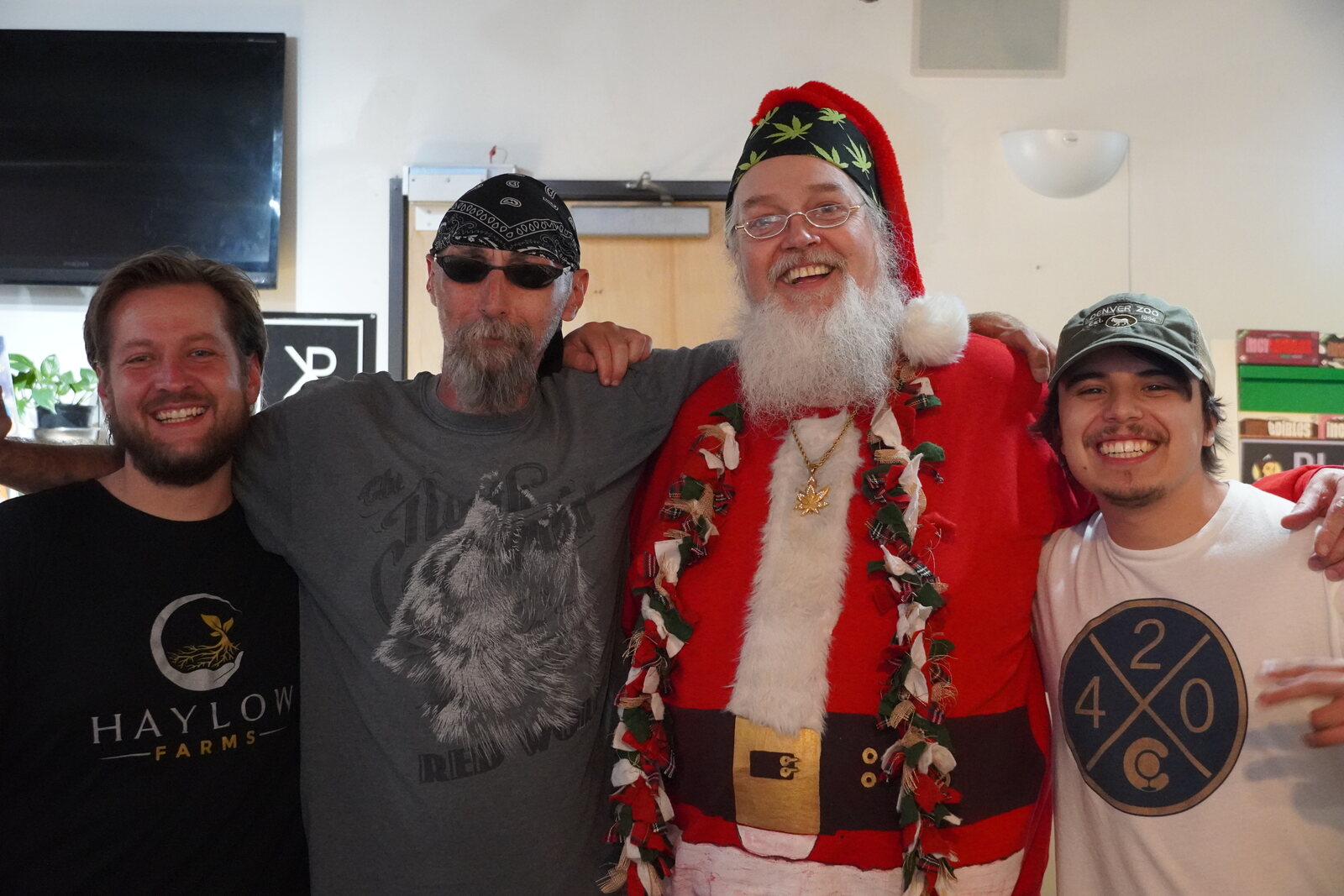 Smoking Santa with three grinning staff members at a Colorado dispensary